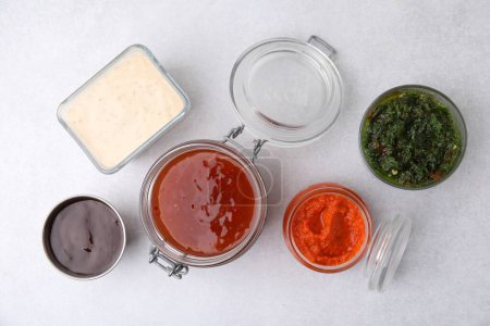 Different marinades on light table, flat lay