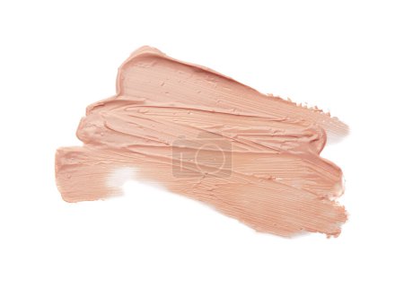 Strokes of pink color correcting concealer on white background, top view