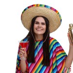 Young woman in Mexican sombrero hat and poncho with shaker and cocktail on white background