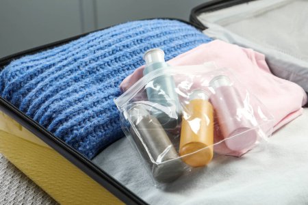 Plastic bag of cosmetic travel kit in suitcase