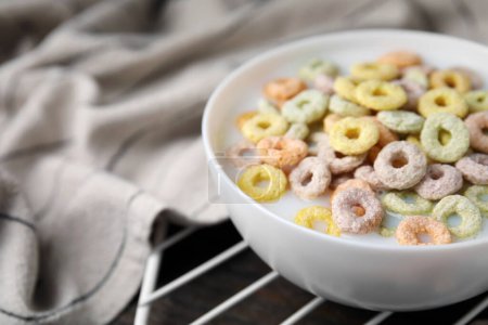 Photo for Cereal rings and milk in bowl on table, closeup. Space for text - Royalty Free Image