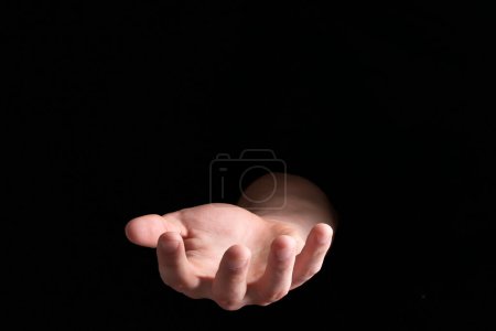 Photo for Man throwing game dices on black background, closeup - Royalty Free Image