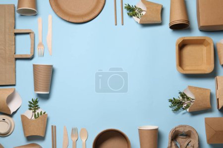 Frame of eco friendly food packagings and twigs on light blue background, flat lay. Space for text