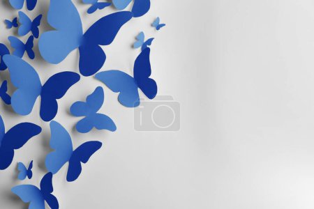 Photo for Bright blue paper butterflies on white wall - Royalty Free Image
