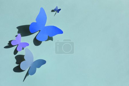 Photo for Colorful bright paper butterflies on light blue wall - Royalty Free Image