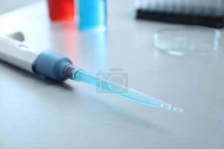 Photo for Laboratory analysis. Micropipette with liquid on grey table, closeup - Royalty Free Image