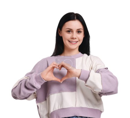 Smiling woman showing heart gesture with hands on white background