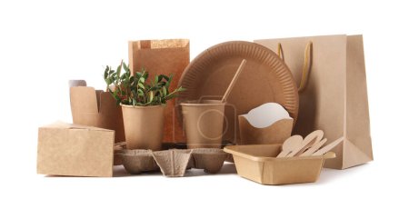 Eco friendly food packagings, tableware, paper bags and twigs isolated on white