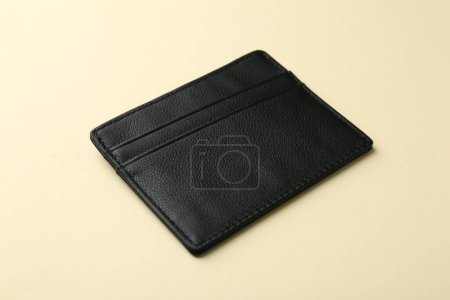 Empty leather card holder on beige background