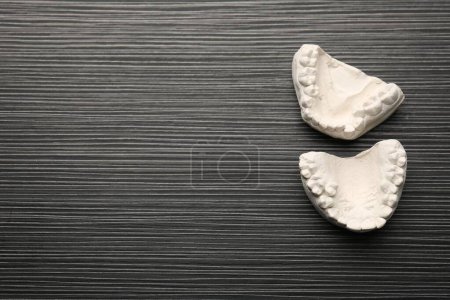 Photo for Dental model with gums and space for text on grey wooden table, top view. Cast of teeth - Royalty Free Image