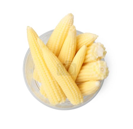 Tasty fresh baby corn in glass isolated on white, top view