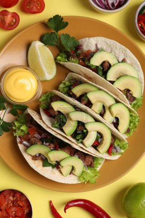 Téléchargez les photos : Composition plate avec de délicieux tacos sur table jaune - en image libre de droit