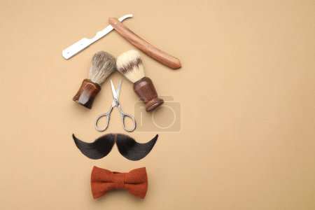 Téléchargez les photos : Moustache artificielle et outils de coiffeur sur fond beige, pose plate. Espace pour le texte - en image libre de droit