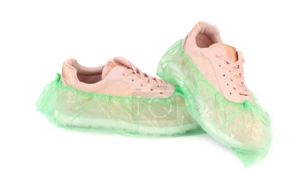 Photo for Sneakers in green shoe covers isolated on white - Royalty Free Image