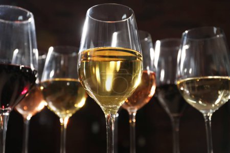 Photo for Different tasty wines in glasses against blurred background, low angle view - Royalty Free Image