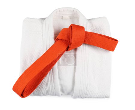 Martial arts uniform with orange belt isolated on white, top view