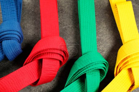 Photo for Colorful karate belts on gray background, flat lay - Royalty Free Image