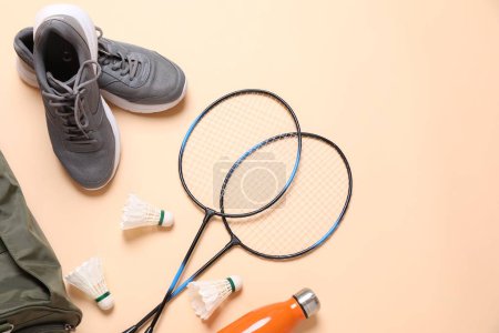 Photo for Badminton set, bag, sneakers and bottle on beige background, flat lay. Space for text - Royalty Free Image