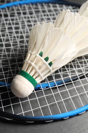 Photo for Feather badminton shuttlecocks and rackets on grey background, closeup - Royalty Free Image