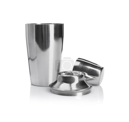 Metal cocktail shaker, strainer and cup isolated on white