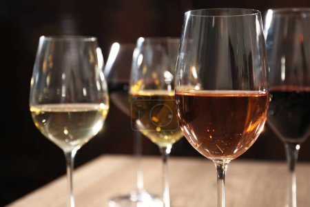 Photo for Different tasty wines in glasses against blurred background, closeup - Royalty Free Image