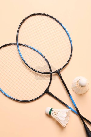 Photo for Feather badminton shuttlecocks and rackets on beige background, flat lay - Royalty Free Image