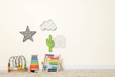 Educational toys and nightlights in beautiful children's room. Space for text