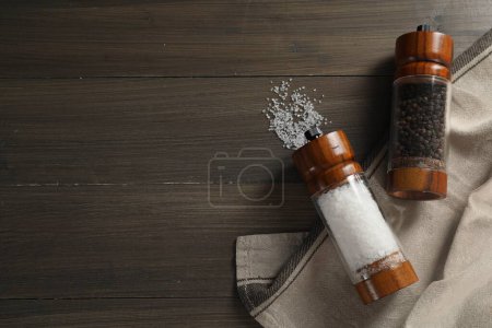 Photo for Salt and pepper shakers on wooden table, flat lay. Space for text - Royalty Free Image