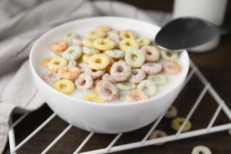 Photo for Cereal rings and milk in bowl on table, closeup - Royalty Free Image