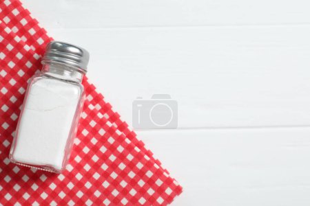 Photo for Salt shaker on white wooden table, top view. Space for text - Royalty Free Image