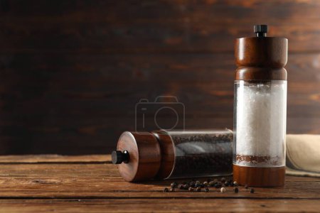 Photo for Salt and pepper shakers on wooden table, space for text - Royalty Free Image