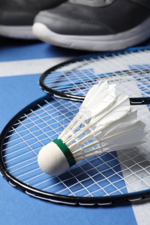 Photo for Feather badminton shuttlecock and rackets on court, closeup - Royalty Free Image