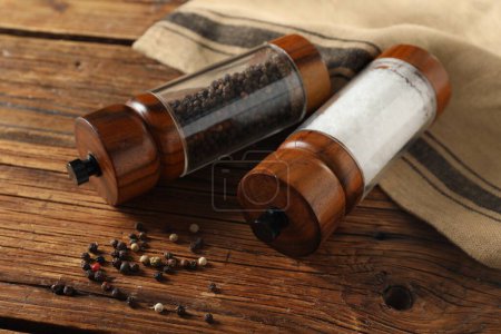 Photo for Salt and pepper shakers on wooden table - Royalty Free Image