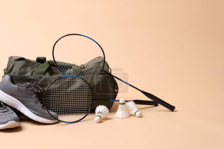 Photo for Badminton set, bag and sneakers on beige background, space for text - Royalty Free Image