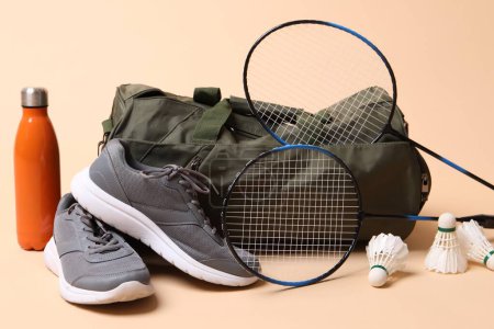 Photo for Badminton set, bag, sneakers and bottle on beige background - Royalty Free Image