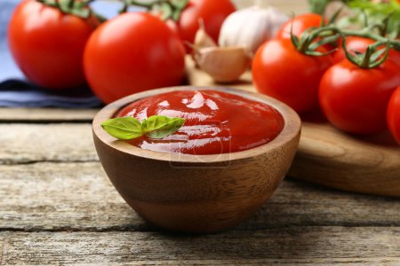 Photo for Tasty ketchup, fresh tomatoes, basil and spices on wooden table - Royalty Free Image