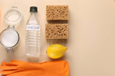 Eco friendly natural cleaners. Flat lay composition with bottle of vinegar on beige background, space for text