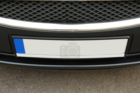 Car with vehicle registration plate outdoors, closeup