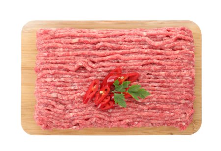 Photo for Board with raw ground meat, chili pepper and parsley isolated on white, top view - Royalty Free Image
