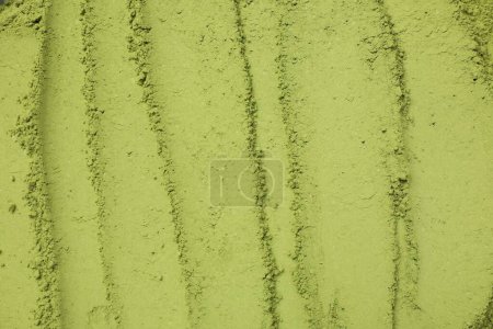 Grünes Matcha-Puder als Hintergrund, Draufsicht