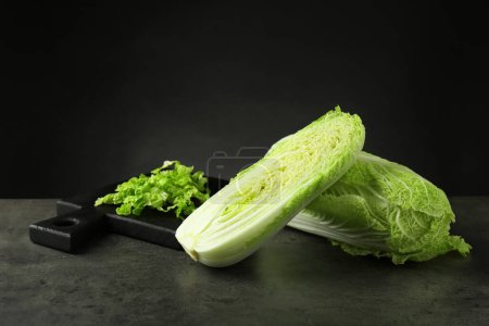 Photo for Whole and cut fresh Chinese cabbages on grey table - Royalty Free Image