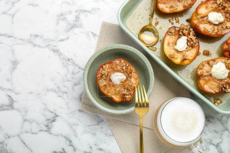Tasty baked quinces with nuts and cream cheese served on white marble table, flat lay. Space for text