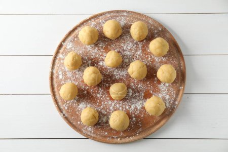 Shortcrust pastry. Raw dough balls on white wooden table, top view