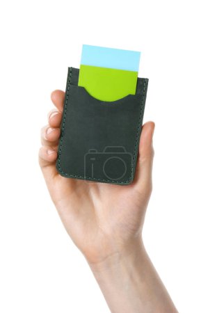 Woman holding leather business card holder with colorful cards on white background, closeup