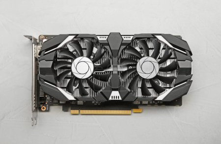 Computer graphics card on gray textured background, top view
