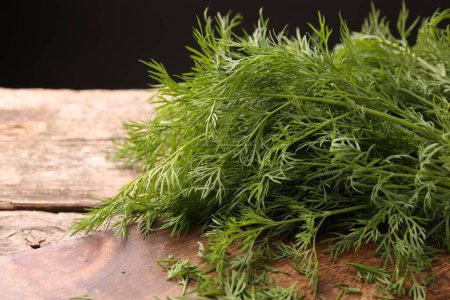Fresh dill on wooden table, closeup. Space for text