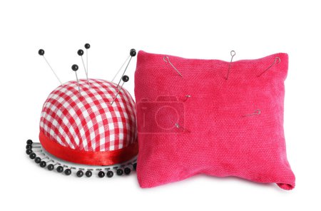 Pincushions, sewing needles and pins isolated on white