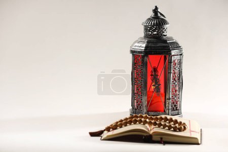 Arabic lantern, Quran and misbaha on light background. Space for text