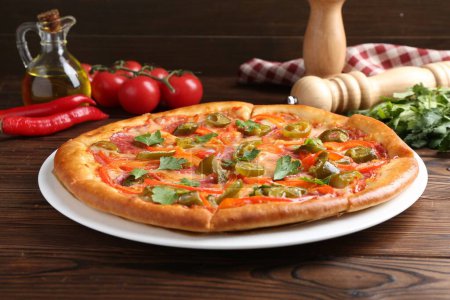 Photo for Delicious pizza Diablo and ingredients on wooden table - Royalty Free Image