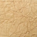 Texture of crumpled old paper as background, top view